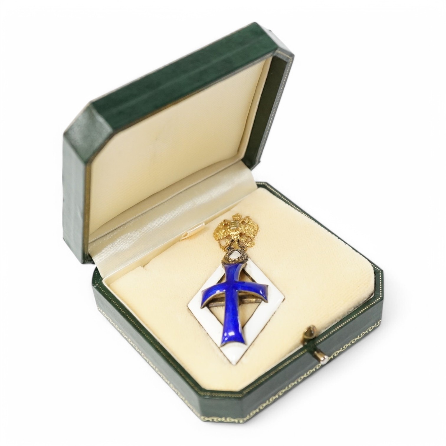 A Russian award issued between 1899-1908 to students who failed to graduate from medical school, known as the Patrikeev-Boynovich badge, enamel on silver with a gilt double eagle. Condition - fair to good, minor damage t